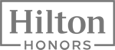 The image shows the logo for "Hilton Honors," a loyalty program by Hilton hotels. The logo features the words "Hilton" and "Honors" in a rectangle.